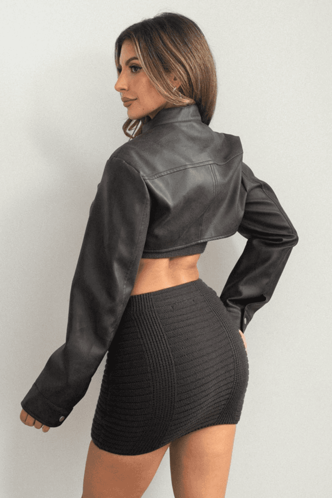 Woman in black jacket and skirt.