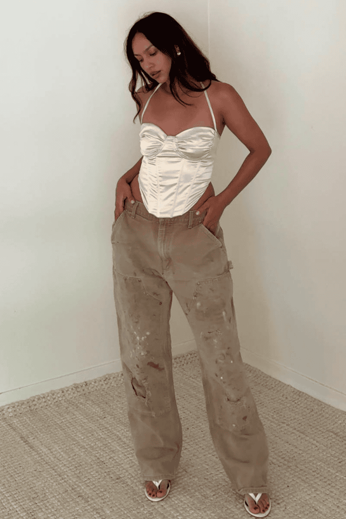 Woman in white top and brown pants.