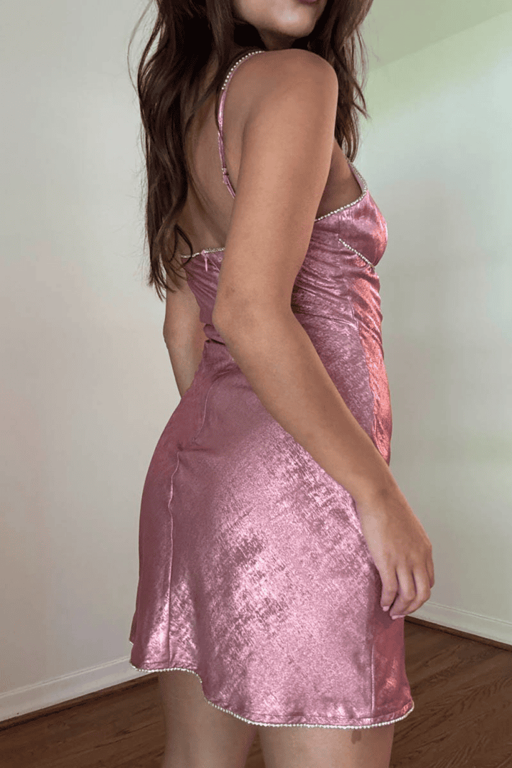 Woman in a pink satin dress.