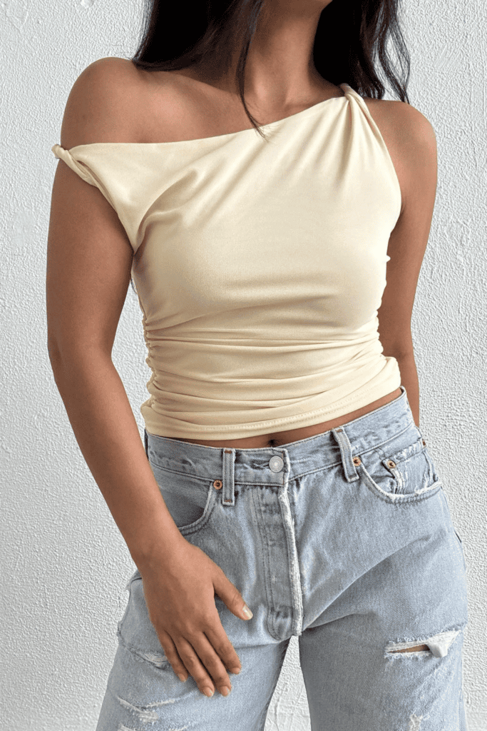 Woman in off-shoulder top and jeans.