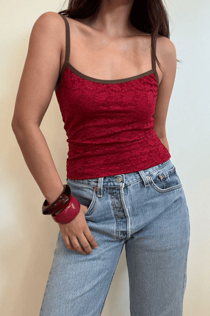 Woman in red top and blue jeans.
